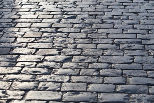 old stone granite pavement. Background close-up.