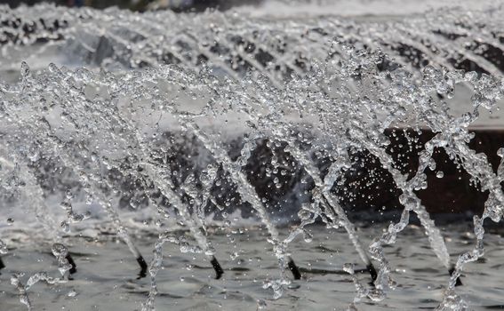 Water jets from the fountain. Detail close-up