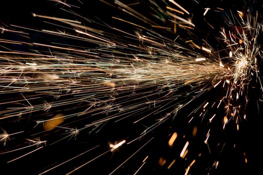 bright sparks of metal against dark background