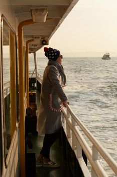 Woman traveling by boat at sunset among the islands