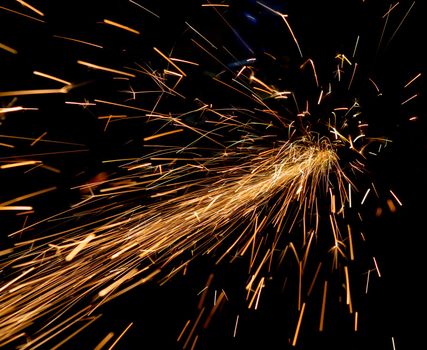 bright sparks of metal against dark background