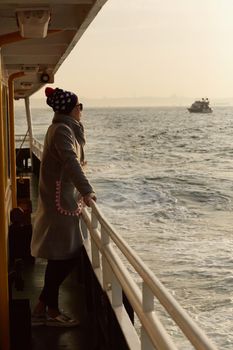 Woman traveling by boat at sunset among the islands