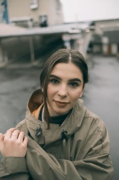 beautiful girl in a raincoat on street