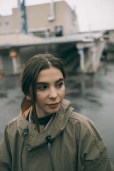 beautiful girl in a raincoat on street