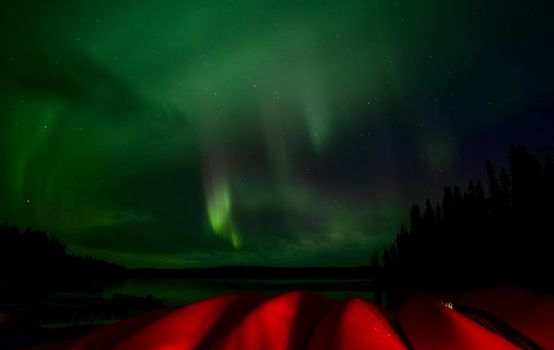 Aurora explosion in Saskatchewan Canada very colorful canoes