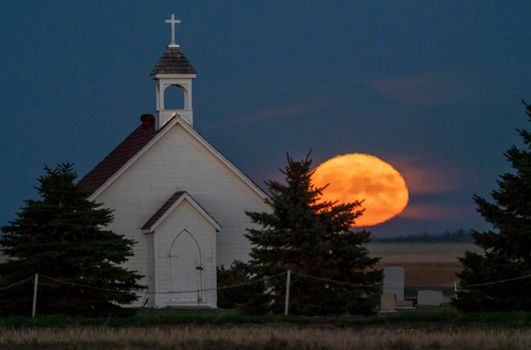 Moon rising over Prairie Country Church Canada