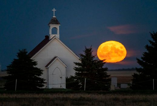 Moon rising over Prairie Country Church Canada