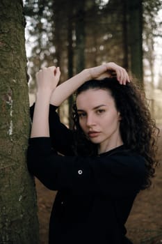 portrait of curly brunette woman in the park