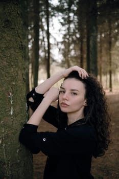 portrait of curly brunette woman in the park