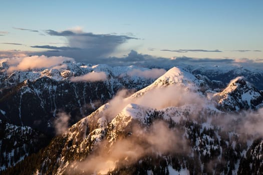 Aerial Landscape View of Coquitlam Mountain during a colorful cloudy sunset. Taken in Vancouver, British Columbia, Canada.