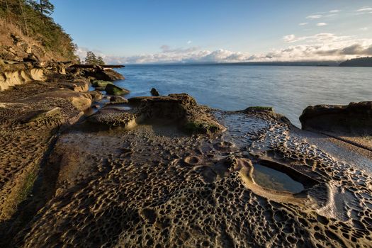 Nature landscape view on a rocky shore during a sunny winter day. Picture taken in Hornby Island, British Columbia, Canada.