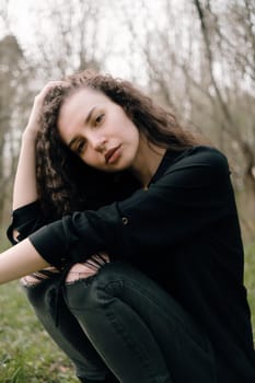 portrait of curly brunette woman in the park