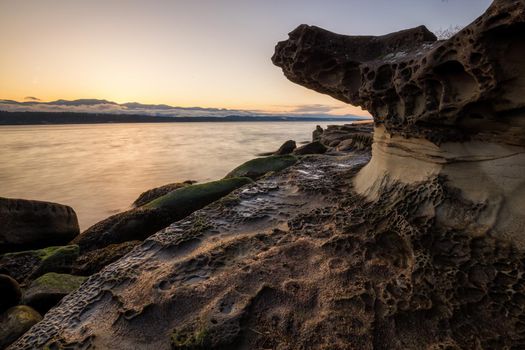 Nature landscape view on a rocky shore during a sunny winter day. Picture taken in Hornby Island, British Columbia, Canada.