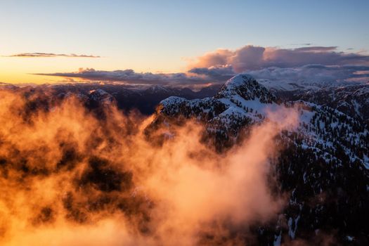 Surreal Aerial Landscape Photograph of Coquitlam Mountain, Vancouver, British Columbia, Canada, during a colorful cloudy sunset.