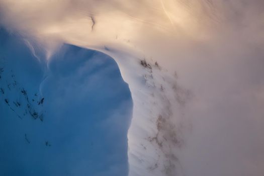 Abstract Aerial View on the top of the snow covered mountain ridge. Picture taken North of Vancouver near Howe Sound, British Columbia, Canada.