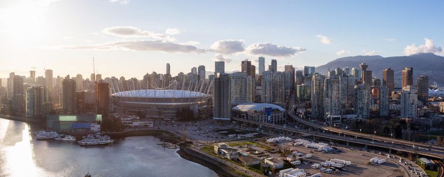 Downtown Vancouver, BC, Canada - Apr 02, 2017 - Aerial Panoramic View of the City Skyline, BC Place Stadium, Rogers Arena, around False Creek during a bright sunset.