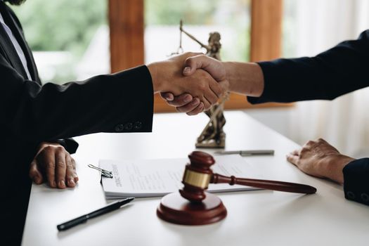 Businessman shaking hands to seal a deal Judges male lawyers Consultation legal services Consulting in regard to the various to plan the case.