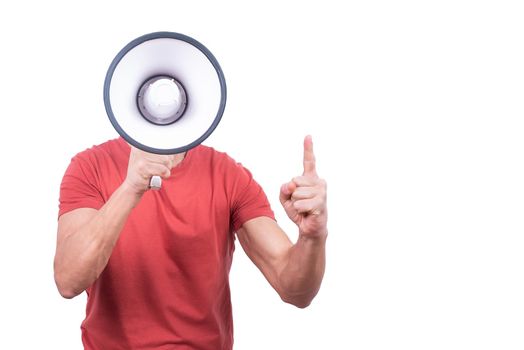 Anonymous guy in red shirt hiding face behind megaphone and bringing attention to something on blank background