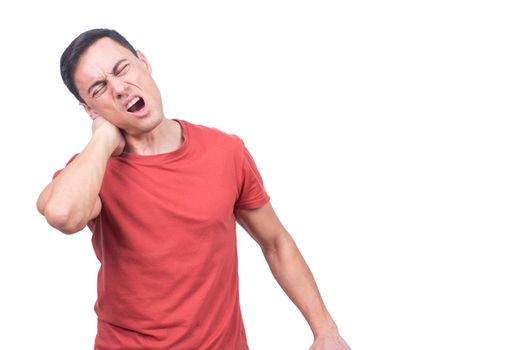 Brunet with closed eyes and opened mouth wearing red t shirt and massaging stiff neck while standing on white background