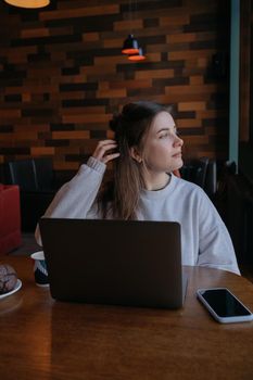 freelance woman happy working in a cafe remotely brunette