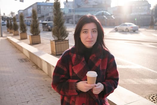 Woman drinking coffee in the sun, outdoor in sunlight light, enjoying her morning