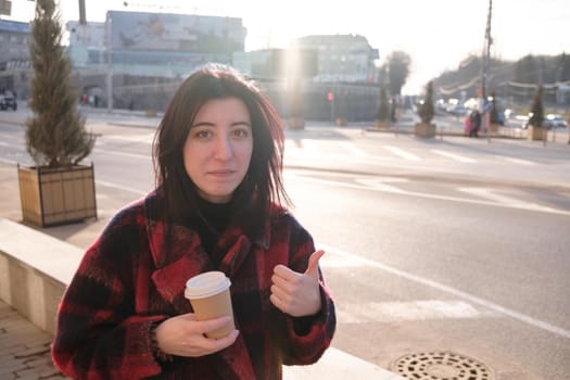 Woman drinking coffee in the sun, outdoor in sunlight light, enjoying her morning