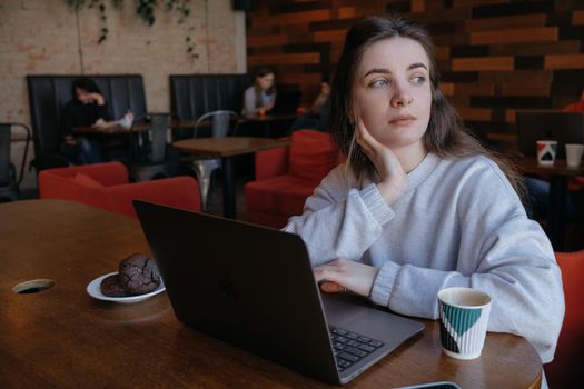 freelance woman happy working in a cafe remotely brunette