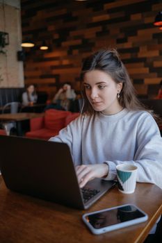 freelance woman happy working in a cafe remotely brunette