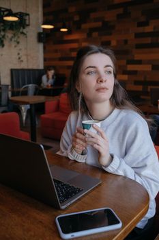 freelance woman happy working in a cafe remotely brunette