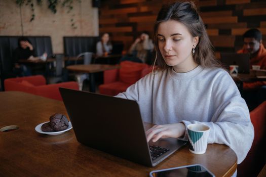 freelance woman happy working in a cafe remotely brunette