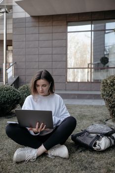 Workation outdoor. Woman working on laptop in park. Distant remote job work during quarantine coronavirus covid-19. Student studying learning online. Video blogger doing live stream.