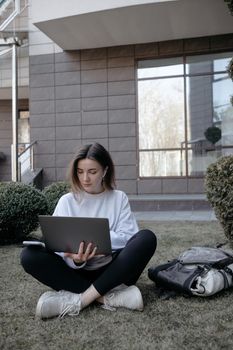 Workation outdoor. Woman working on laptop in park. Distant remote job work during quarantine coronavirus covid-19. Student studying learning online. Video blogger doing live stream.