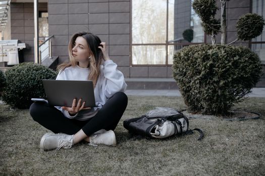 Workation outdoor. Woman working on laptop in park. Distant remote job work during quarantine coronavirus covid-19. Student studying learning online. Video blogger doing live stream.