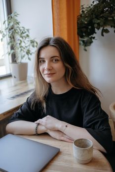 freelance woman happy working in a cafe remotely brunette