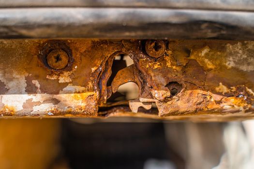 Rusty car door lock. A rotten lock mount on a minivan liftgate. body corrosion