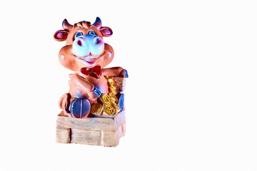 a flat, typically round piece of metal with an official stamp, used as money.Toy cow sitting on a chair with gold coins money.