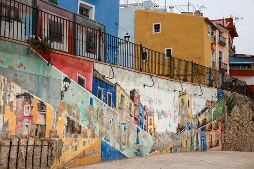 Villajoyosa, Alicante, Spain- April 22, 2022:Beautiful mural on the wall and Old colorful facades in Villajoyosa, Alicante, Spain