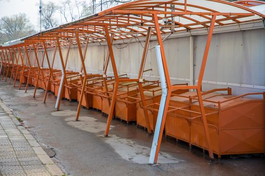day view of many empty market stalls .