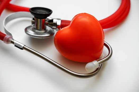 Stethoscope and red heart on white background, heart health, health insurance concept.