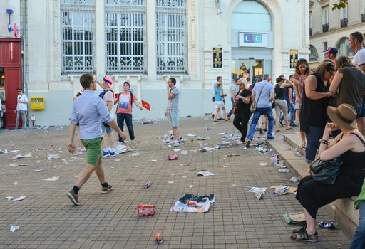 LE MANS, FRANCE - JUNE 16, 2017: Garbage from cans and plastic and paper on the street after the parade of pilots racing in Le mans, France
