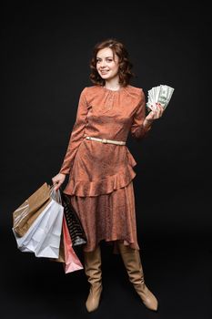 03 16 2020 Belarus Minsk: Shopping concept. Happy and satisfied asian woman winning prize money, showing dollars and rejoicing, standing over pink background,