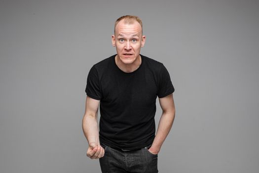 picture of caucasian man rages and argues isolated on grey background