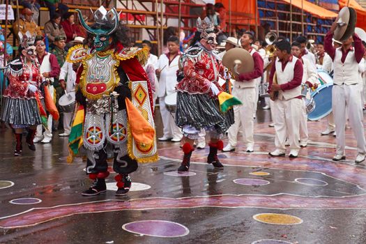 ORURO, BOLIVIA - FEBRUARY 25, 2017: Diablada dancers in ornate costumes parade through the mining city of Oruro on the Altiplano of Bolivia during the annual carnival.