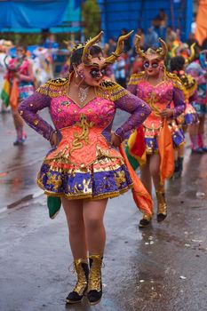 ORURO, BOLIVIA - FEBRUARY 25, 2017: Diablada dancers in ornate costumes parade through the mining city of Oruro on the Altiplano of Bolivia during the annual carnival.