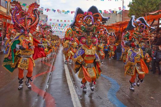 ORURO, BOLIVIA - FEBRUARY 25, 2017: Diablada dancers in ornate costumes parade through the mining city of Oruro on the Altiplano of Bolivia during the annual carnival.