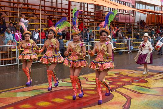 ORURO, BOLIVIA - FEBRUARY 25, 2017: Female Morenada dancers in colourful costumes parading through the mining city of Oruro on the Altiplano of Bolivia during the annual Oruro Carnival.