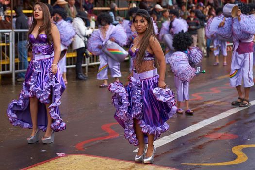 ORURO, BOLIVIA - FEBRUARY 25, 2017: Female dancers in colourful costumes parade through the mining city of Oruro on the Altiplano of Bolivia during the annual carnival.