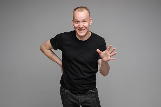 picture of handsome caucasian male explain something isolated on grey background