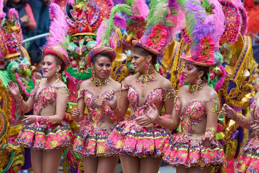 ORURO, BOLIVIA - FEBRUARY 25, 2017: Female Morenada dancers in colourful costumes parading through the mining city of Oruro on the Altiplano of Bolivia during the annual Oruro Carnival.