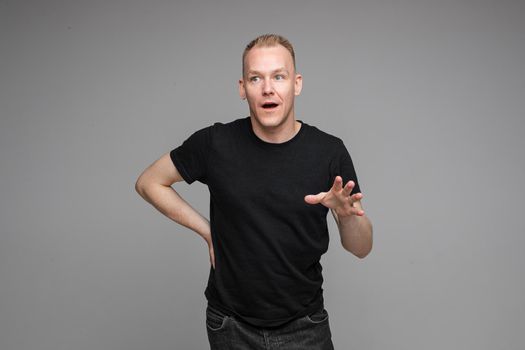picture of handsome caucasian male explain something isolated on grey background
